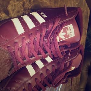 Burgundy high top adidas sneakers